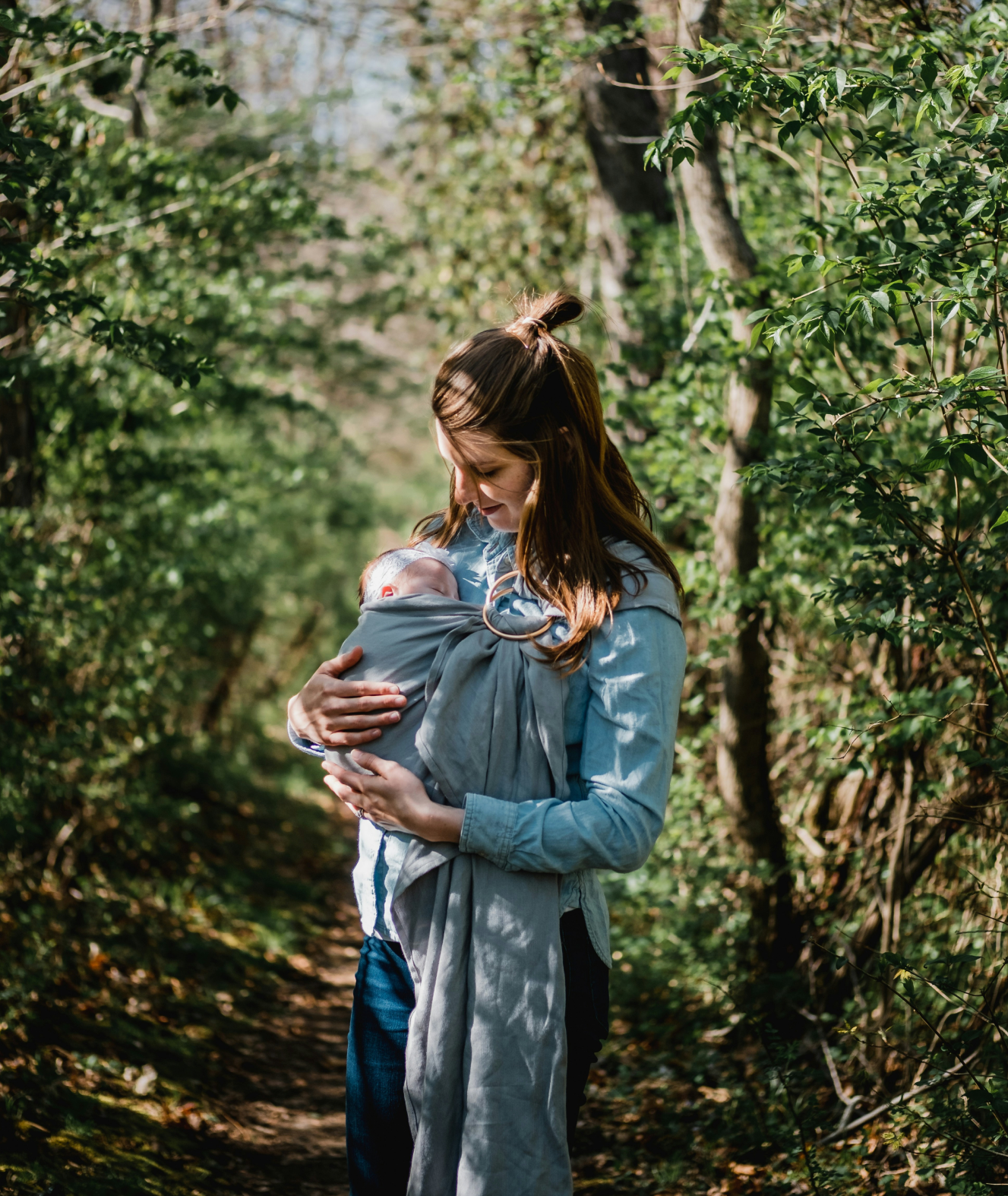 A mom with her baby in the woods